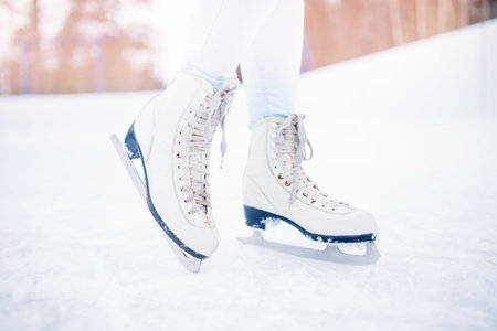 Close-up of women figure skates on ice rink in winterの写真素材
