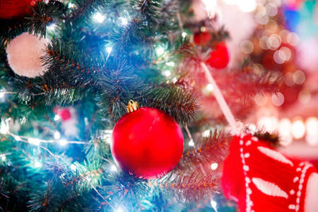 Blue light color decorated christmas tree pine on blurred background bokehの写真素材
