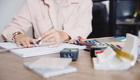 Closeup Professional Architect and interior designer working in workplace, draw new project with art toolsの写真素材