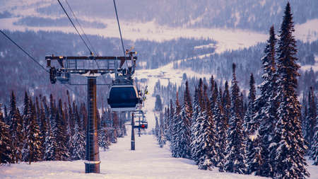 Landscape mountain ski lift resort in winter forest sunset, aerial top view Kemerovo region Russiaの写真素材
