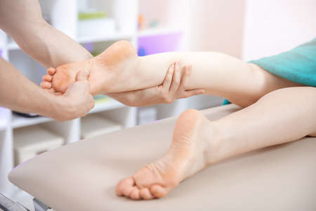 Closeup hand of therapist osteopathy working sports massage with woman footの写真素材