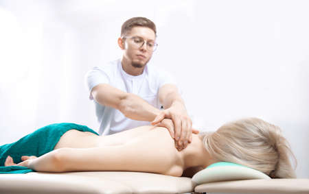 Osteopath therapy physiotherapy massage for woman backの写真素材