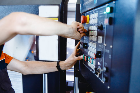 Industry Worker hand use tool and button for installation lathe machine on factory floorの写真素材