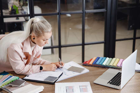 Happy Woman creative Interior designer working at office workplace with laptop.Online consultation with client through video callの写真素材