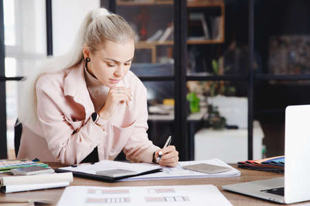 Woman professional architect and interior designer working in workplace, draw apartment plan on laptopの写真素材