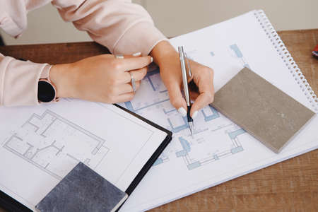 Top view professional architect and interior designer working in workplace, draw apartment plan on laptopの写真素材