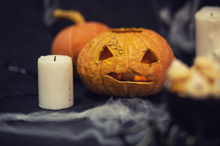 Halloween Dark background with pumpkin head, cobwebs and candlesの写真素材