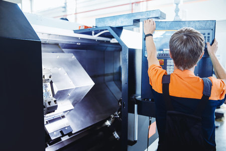 Worker use tool on lathe machine on factory floor. Industry portrait people