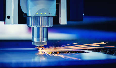 Concept banner background modern industrial technology. CNC Laser engraving cutting of heavy metal with light sparkの写真素材