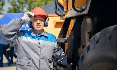 Driver yellow big truck on coal at open pit mining. Concept industry man workerの写真素材