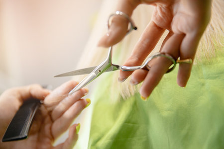 Hands of hairdresser at work in female beauty salonの写真素材