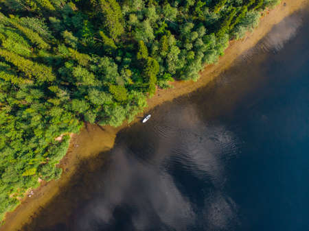 Woman rowing oar on sup board blue sea water. Aerial top view paddleboardの写真素材