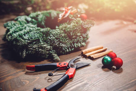 Christmas craft wreath on brown wooden table decorations DIY, top viewの写真素材