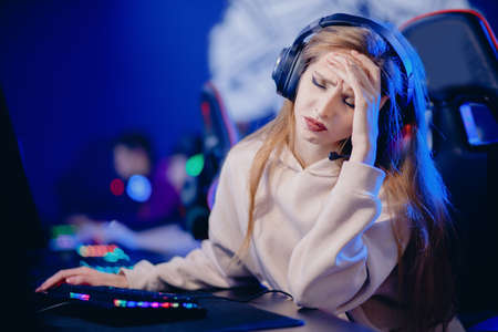 Facepalm streamer caucasian woman fail losing play gamer playing online video games computer emotions aggression, neon colorの写真素材