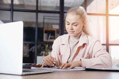 Professional architect and interior designer young woman working in workplace, draw apartment plan with art toolsの写真素材