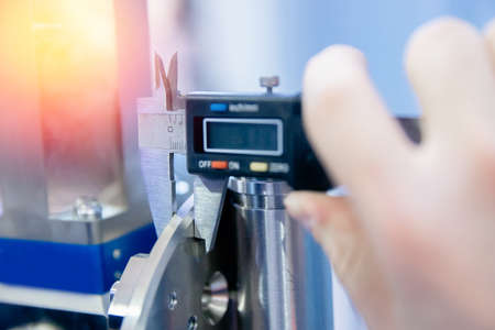 Closeup Engineer checks quality of detail for engine at car manufacturing plant, industry conceptの写真素材