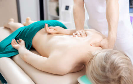 Woman having therapy Professional back massage medical clinicの写真素材