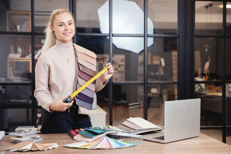 Young Woman creative Interior designer working at office workplace with laptopの写真素材