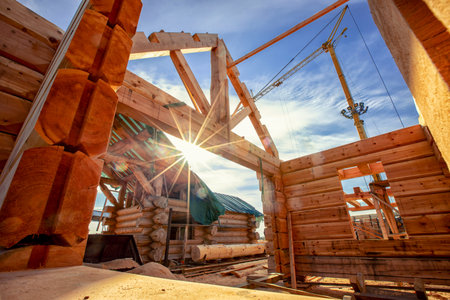 Country house cottages of wooden log under open construction roof, rural properties with sun lightの写真素材