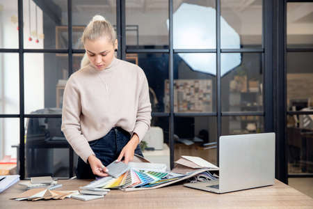 Happy Woman creative Interior designer working at office workplace with laptop.Online consultation with client through video callの写真素材