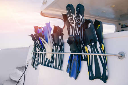 Closeup of flippers, Banner photo tour on boat snorkeling or diving underwater in seaの写真素材
