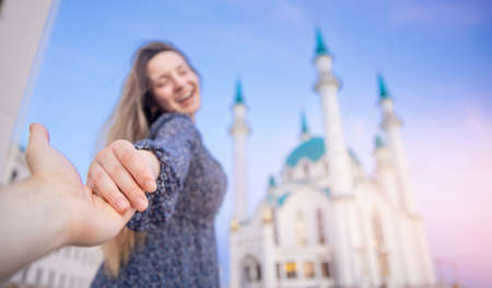 Man hold hand of woman on background sunset Kul Sharif Mosque islam Kazan Kremlin. Concept couple lover freedom muslim with religionの写真素材