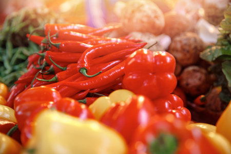 Red and yellow sweet paprika peppers on bazaar counter in Egypt with sunlight. Farm products conceptの写真素材
