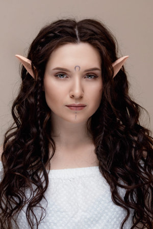 Concept creative photography beauty skin care. Beautiful fashion brunette woman elf with extended fake eyelashesの写真素材