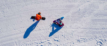 Snowboarder riding winter road snow, aerial top view bannerの写真素材