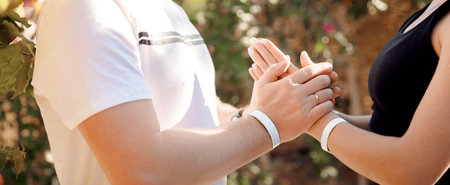 Closeup hand of couple lover young woman and man doing asana yoga background sunlight. Concept of support, family values, equalityの写真素材
