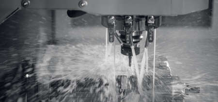 Auto CNC turning with robot drill milling factory with water coolant streams. Concept metal machine industry backgroundの写真素材