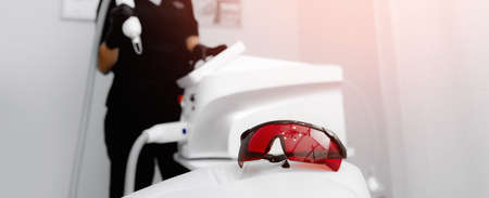 Banner removal tattoo and permanent makeup by laser, closeup of protective glassesの写真素材