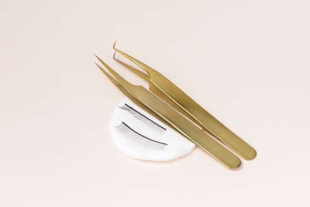 Minimalism Set black lashes and tools for eyelash extension procedure light background, top viewの写真素材