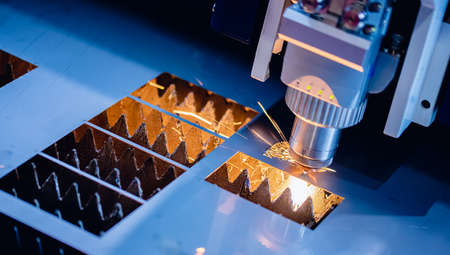 Industrial background CNC laser machine cutting sheet metal with light spark. Concept modern steel technology, blue colorの写真素材