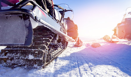 Winter snow tour banner. Close up of snowmobile with sun glareの写真素材