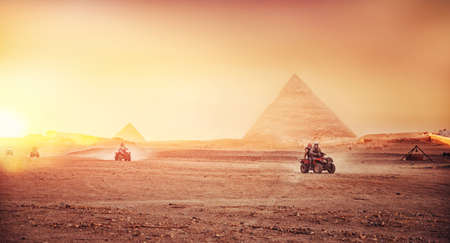 Quad bikes ATV safari in desert background Pyramids Sphinx Cairo, Egyptの写真素材
