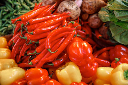 Farm market products concept. Red and yellow sweet paprika peppers on bazaar counter in Egyptの写真素材