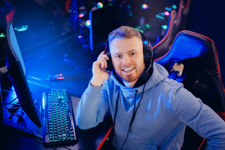 Streamer young man professional gamer playing online games computer with headphones make selfie photo, neon colorの写真素材