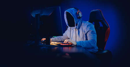 Concept banner anonymous hacking, malware or gamer playing online games computer, neon dark colorの写真素材
