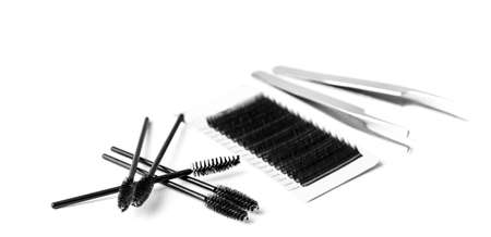 Set black lashes and brush tweezers in white isolated background, eyelash extension conceptの写真素材