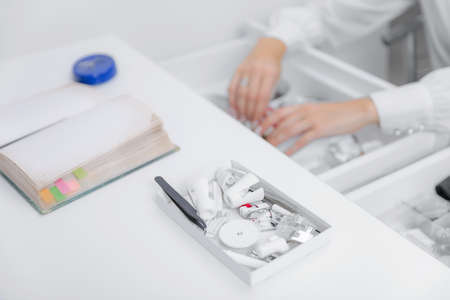 Selective focus Tool for sewing machine, colored threads are in box, top view sun lightの写真素材