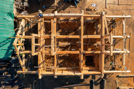Construction industry concept. Timber wooden frame of house from bar, foundations of villas. Aerial top viewの写真素材