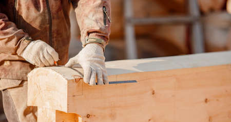 Carpenter worker with log wooden. Woodwork job, house frame buildingの写真素材