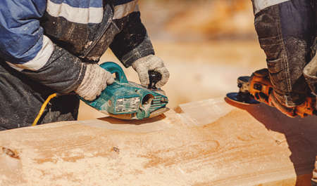 Carpenter worker with log wooden. Woodwork job, house frame buildingの写真素材