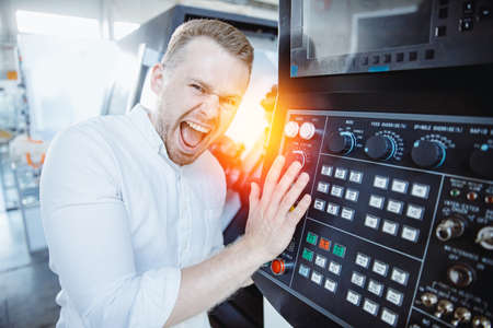 Industry Worker use button for accident attention lathe machine on factory floorの写真素材