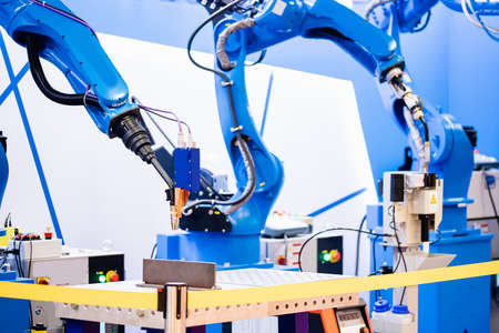 Automatic team robot welding by hand in industrial production of metal structuresの写真素材