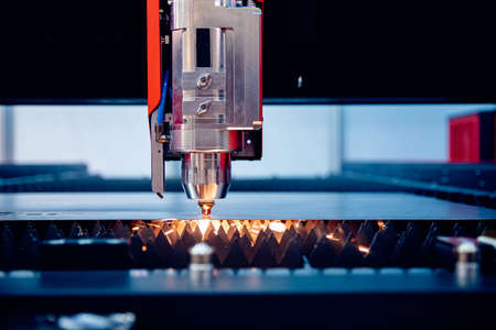 Laser CNC cut of metal with light spark Blue color, technology industrial modernの写真素材