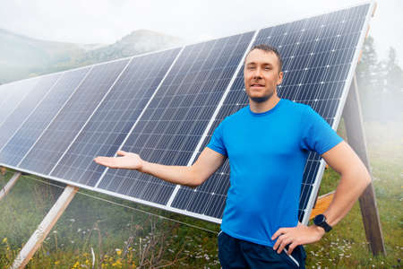 Young male engineer background solar panels with sun lightの写真素材