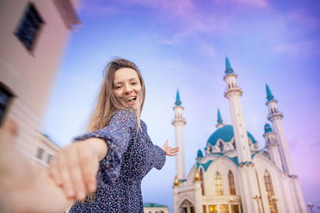 Couple tourist man and woman on background sunset Kul Sharif Mosque islam Kazan Kremlin. Concept tourism freedom muslim with religionの写真素材