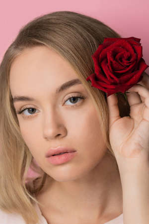 Concept spa lash and hair. Fashion natural beauty caucasian young blond woman smiling over pink backgroundの写真素材